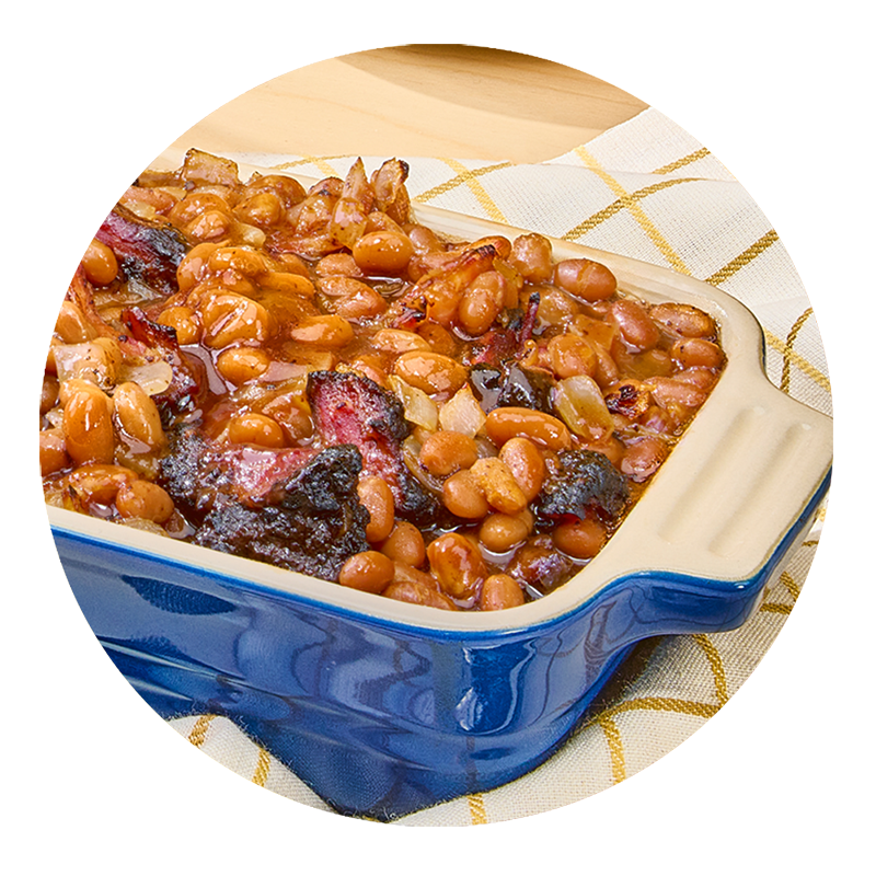 Burnt ends and baked beans in a blue casserole dish